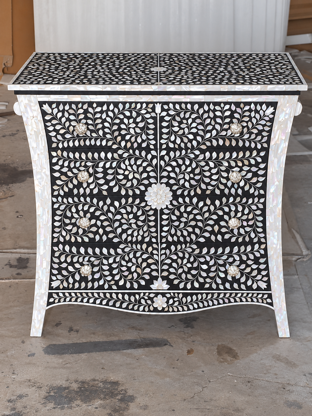 Black mother of pearl inlay chest of drawers with eight drawers and handmade floral vine design